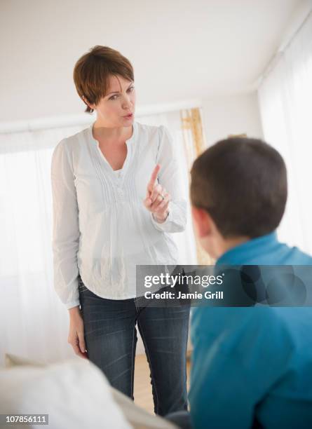 mother discipling son - scolding stock pictures, royalty-free photos & images