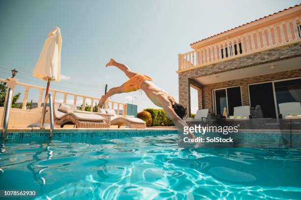 young man diving into the swimming pool - pafos imagens e fotografias de stock