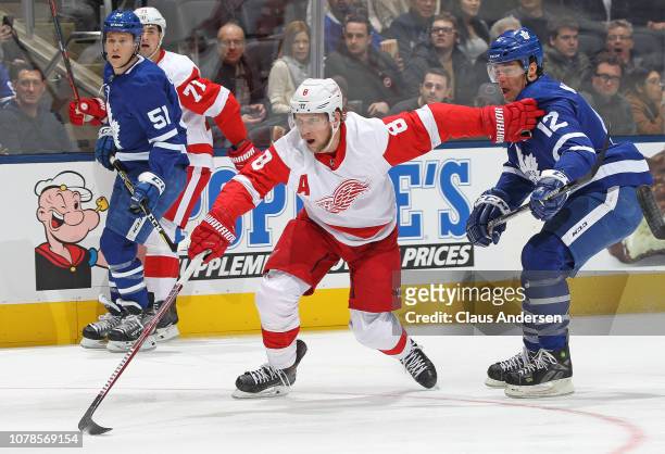 Justin Abdelkader of the Detroit Red Wings skates against Patrick Marleau of the Toronto Maple Leafs during an NHL game at Scotiabank Arena on...