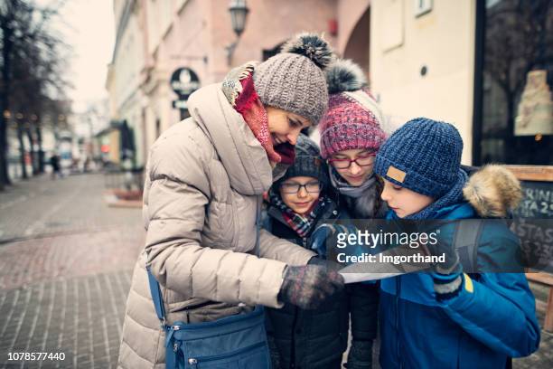happy family walking streets of old town in vilnius, lithuania - vilnius stock pictures, royalty-free photos & images