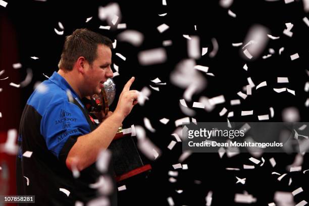 Adrian Lewis of England holds the trophy after winning against Gary Anderson of Scotland in the Final of the 2011 Ladbrokes.com World Darts...