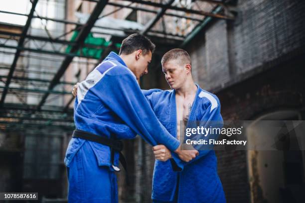 judo practitioners fighting in kimono - jiu-jitsu stock pictures, royalty-free photos & images
