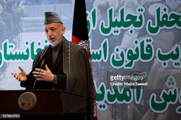 Afghan President Hamid Karzai gestures as he speaks during a gathering to mark the seventh adoption year of Afghanistan's post-Taliban Constitution...