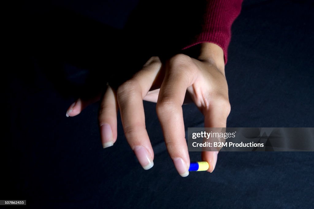 Woman hand with pill