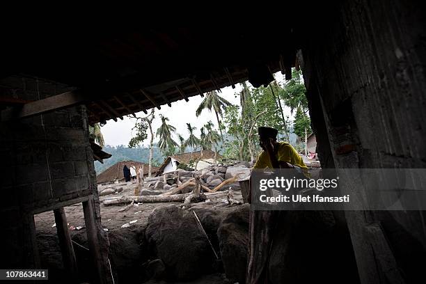 Ngaidi , sits in his destroyed home after volcanic mudflows forced evacuations on January 4, 2011 in Magelang, Central Java, near in Yogyakarta,...