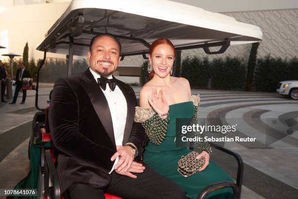 Barbara Meier and her fiance Klemens Hallmann pose in a golf cart that will take them to the red carpet of the 76th annual Golden Globe Awards at...