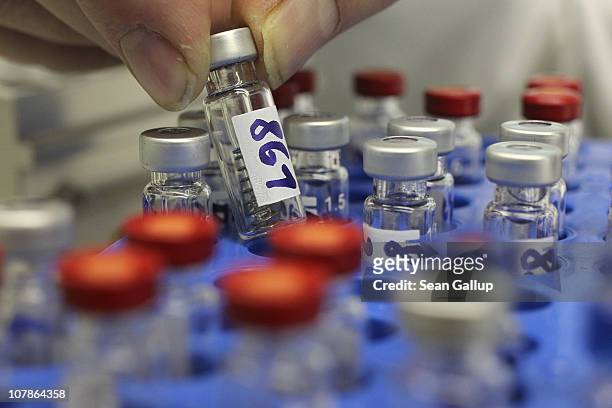 Lab worker prepares vials containing samples of animal feed, pork and poultry for analysis for possible dioxin contamination at the State Office for...
