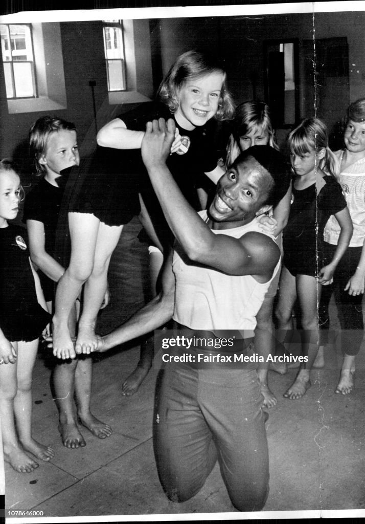 Ronne Arnold holds tiny jazz dance student Lucy Clayton