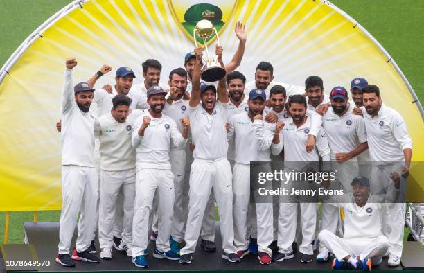 India celebrate with the trophy after a 2-1 series win after day five of the Fourth Test match in the series between Australia and India at Sydney...