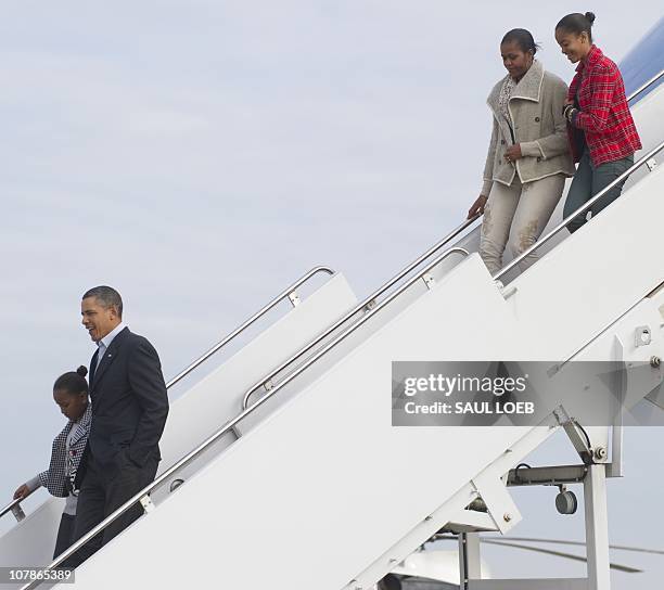 President Barack Obama and his daughter Sasha walk down the steps of Air Force One followed by First Lady Michelle Obama and daughter Malia after...