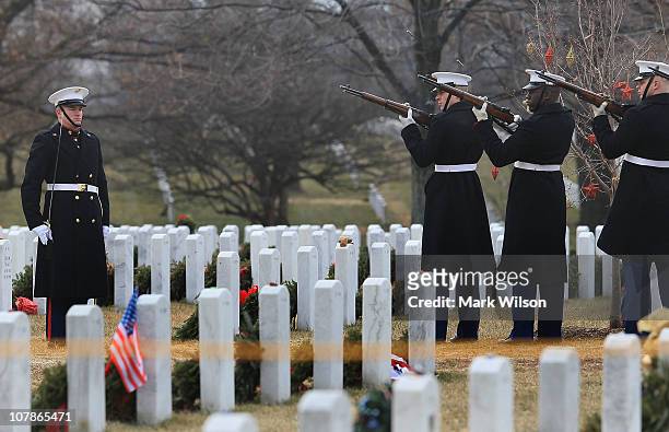 Marine firing party fires a 21 gun salute volley during a burial service for U.S. Marine Cpl. Sean A. Osterman at Arlington Cemetery on January 4,...