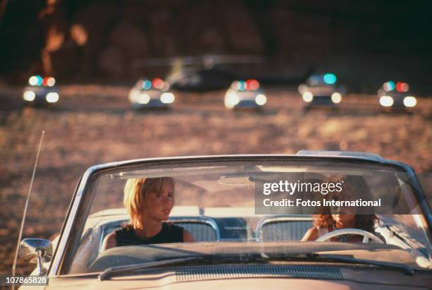 Actresses Geena Davis and Susan Sarandon weigh up their options in the film 'Thelma And Louise', 1991.