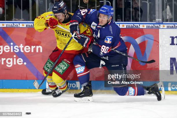 Ken Andre Olimb of Duesseldorf is challenged by Luke Adam of Mannheim during the DEL match between Adler Mannheim and Duesseldorfer EG at SAP Arena...