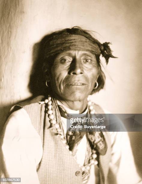 Woopa, a Moqui Indian, Hopi tribe, half-length portrait, facing front, 1902.