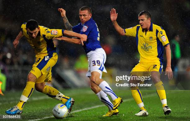 Cardiff player Craig Bellamy challenges Leeds players Robert Snodgrass and Paul Connolly during the npower Championship game between Cardiff City and...