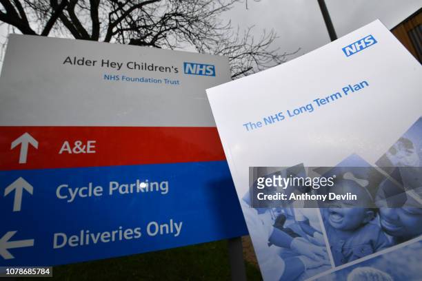 Copy of 'The NHS Long Term Plan' booklet is seen next to a sign for Alder Hey Children's Hospital on January 7, 2019 in Liverpool, England. The Prime...