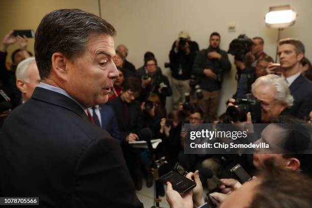 Former Federal Bureau of Investigation Director James Comey talks to reporters after testifying to the House Judiciary and Oversight and Government...