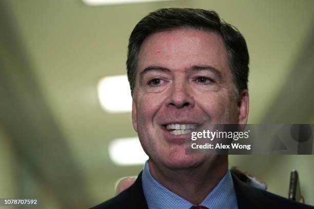 Former Federal Bureau of Investigation Director James Comey speaks to members of the media at the Rayburn House Office Building after testifying to...