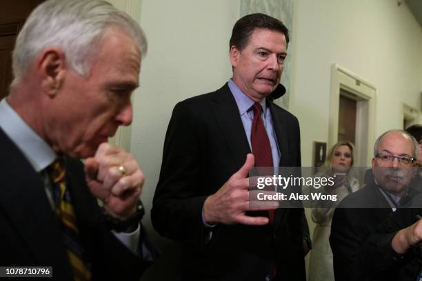 Former Federal Bureau of Investigation Director James Comey reacts as he approaches the microphone to speak to members of the media at the Rayburn...