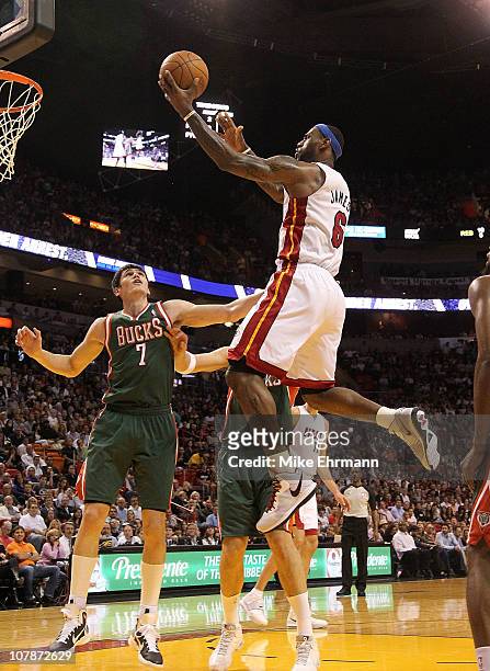 LeBron James of the Miami Heat drives to the rim over Ersan Ilyasova of the Milwaukee Bucks during a game at American Airlines Arena on January 4,...