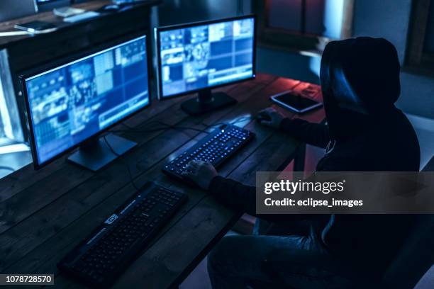 hacker trying to stay anonymous - ransomware stock pictures, royalty-free photos & images