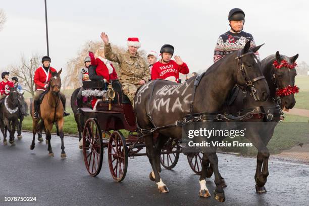 Soldiers from the King's Troop Royal Horse Artillery dressed up in Christmas jumpers and outfits seen out for a traditional Christmas Eve horse ride...