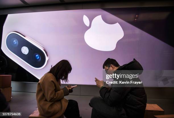 Customers gather as they take part in a class to learn how to use their iPhones at an Apple Store on January 7, 2019 in Beijing, China. Apple Inc....