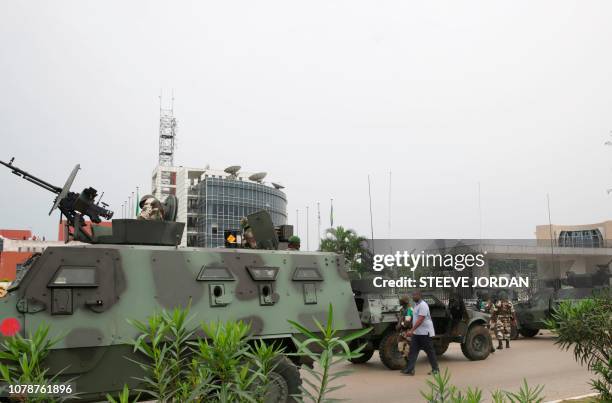 Gabonese soldiers stand in front of the headquarters of the national broadcaster Radiodiffusion Television Gabonaise in Libreville on January 7, 2019...