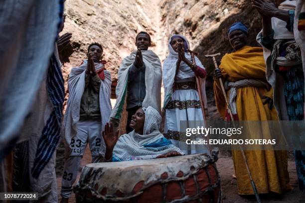 Ethiopian Orthodox pilgrims sing during the Christmas Eve celebration at Saint George Church in Lalibela, on January 06, 2019. - The Ethiopian...