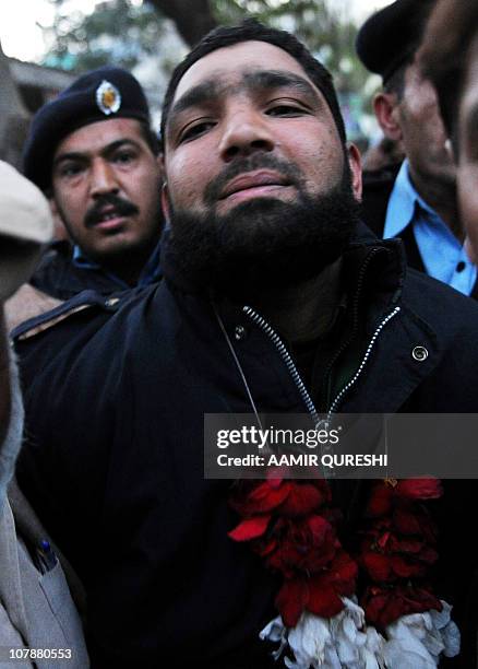 Arrested Pakistani bodyguard Malik Mumtaz Hussain Qadri wearing garland leaves the court in Islamabad on January 5, 2011 a day after the...