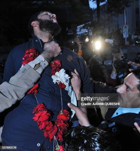 Arrested Pakistani bodyguard Malik Mumtaz Hussain Qadri wearing a garland shouts "We are ready to sacrifice our life for the prestige of the Prophet...