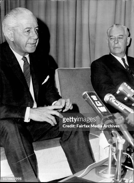 Prime Minister Holt at Press conference at Sydney airport tonight after arriving home from Manills meeting. He is pictured with Mr. Hasluck and New...