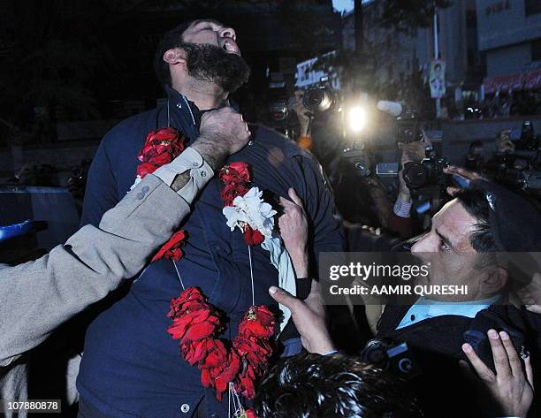 Arrested Pakistani bodyguard Malik Mumtaz Hussain Qadri wearing a garland shouts "We are ready to sacrifice our life for the prestige of the Prophet...