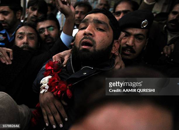 Arrested Pakistani bodyguard Malik Mumtaz Hussain Qadri wearing a garland leaves the court in Islamabad on January 5, 2011 a day after the...
