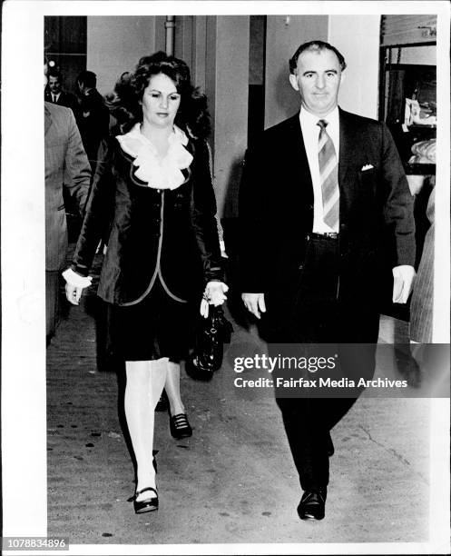 Miss Sharon Hamilton, a witness in the Leonard case, as she arrives at central court with Det. Sgt. R.W. Shankelton, who is in charge of the case....