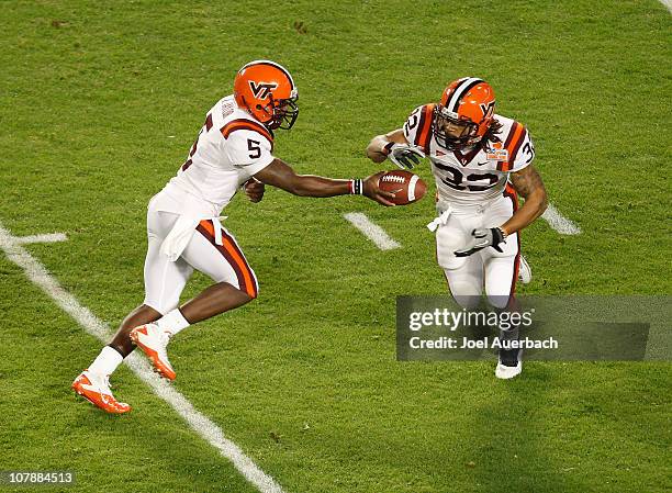 Tyrod Taylor hands the ball off to Darren Evans of the Virginia Tech Hokies against the Stanford Cardinal during the 2011 Discover Orange Bowl at Sun...