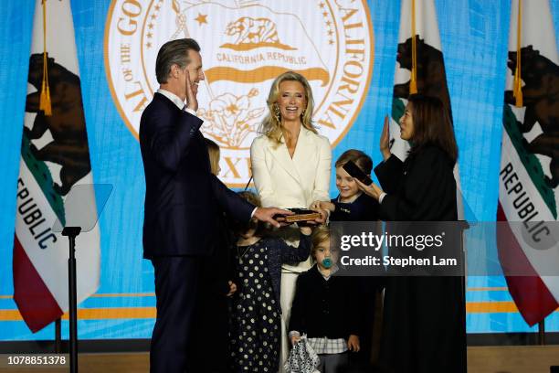 Gavin Newsom is sworn in as governor of California by California Chief Justice Tani Gorre Cantil-Sakauye as Newsom's wife, Jennifer Siebel Newsom ,...