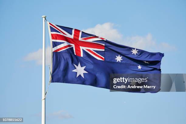 australian flag flying in the wind with blue sky - australian politics stock pictures, royalty-free photos & images