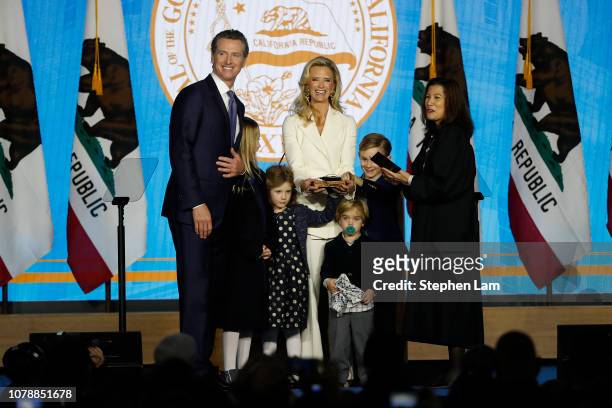 Gavin Newsom is sworn in as governor of California by California Chief Justice Tani Gorre Cantil-Sakauye as Newsom's wife, Jennifer Siebel Newsom ,...