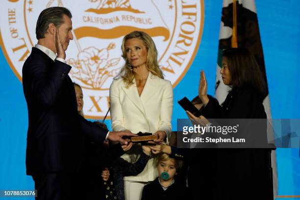 Gavin Newsom is sworn in as governor of California by California Chief Justice Tani Gorre Cantil-Sakauye as Newsom's wife, Jennifer Siebel Newsom ,...