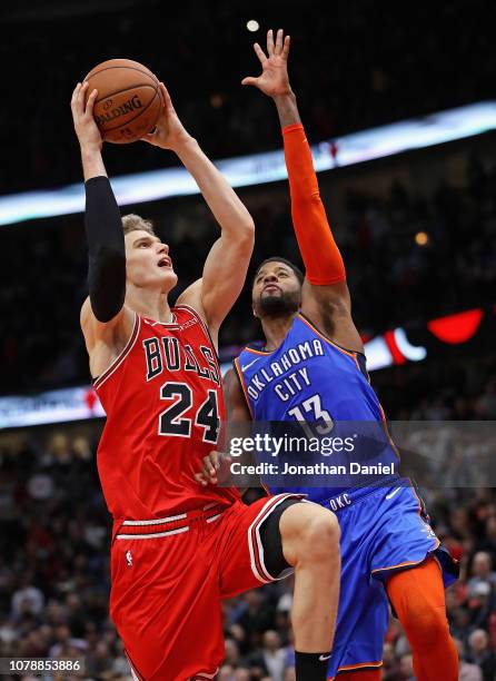 Lauri Markkanen of the Chicago Bulls puts up the game-winning shot against Paul George of the Oklahoma City Thunder at the United Center on December...