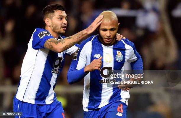 Porto's Algerian forward Yacine Brahimi is congratulated by teammate Mexican forward Jesus Corona after scoring a goal during the Portuguese League...