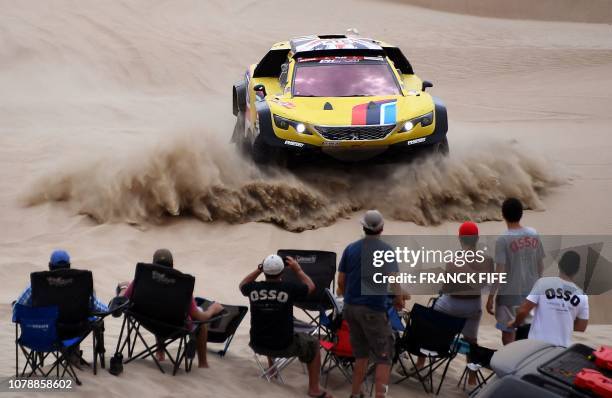 Peugeot's British driver Harry Hunt and Dutch co-driver Wouter Rosegarr compete during Stage 1 of the Dakar 2019 between Lima and Pisco, Peru, on...