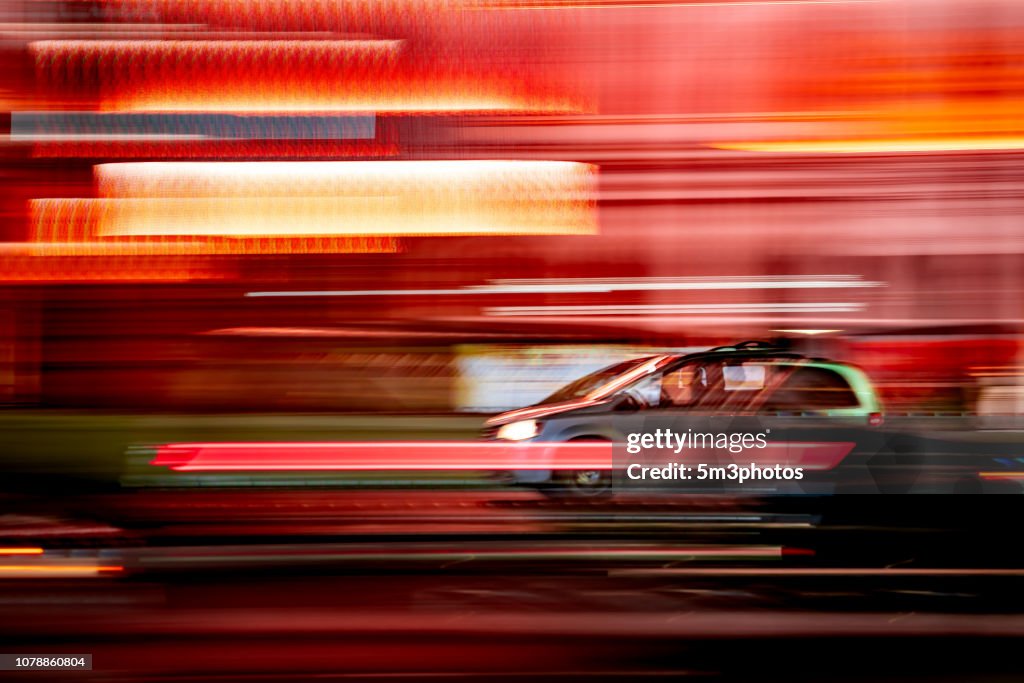 Car motion blur on city street at night