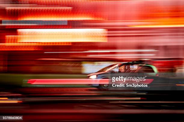 car motion blur on city street at night - street light stock pictures, royalty-free photos & images