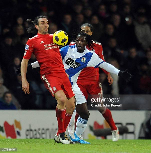 Sotirios Kyrgiakos of Liverpool competes with Benjani of Blackburn Rovers during a Barclays Premier League match between Blackburn Rovers and...