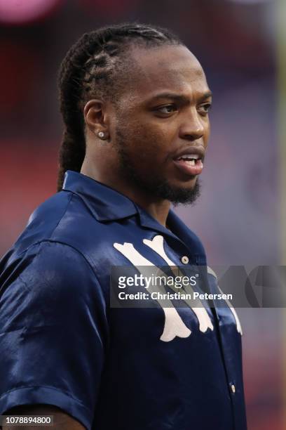 Former Alabama Crimson Tide and current Tennessee Titans player Derrick Henry looks on during warm ups prior to the CFP National Championship between...