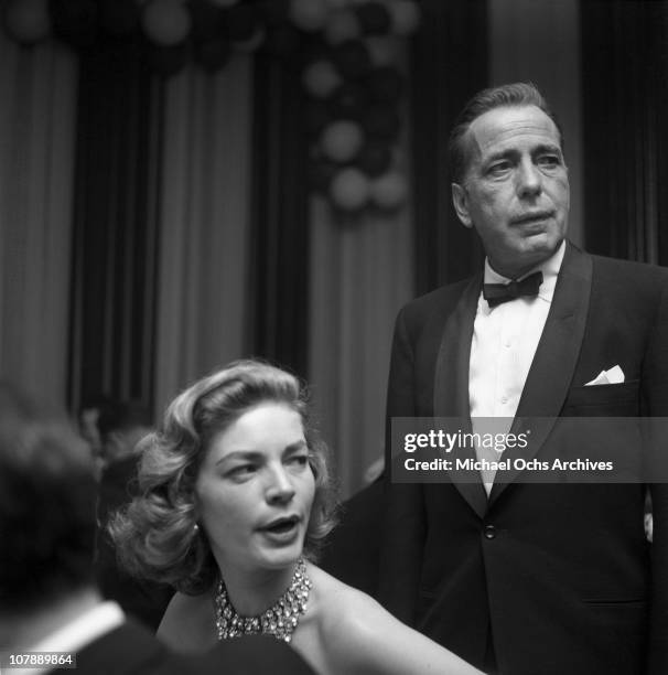 Actors Humphrey Bogart and Lauren Bacall attend the Academy Awards on March 30, 1955 in Los Angeles, California.