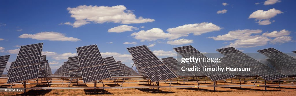 Solar farm with blue sky and clouds