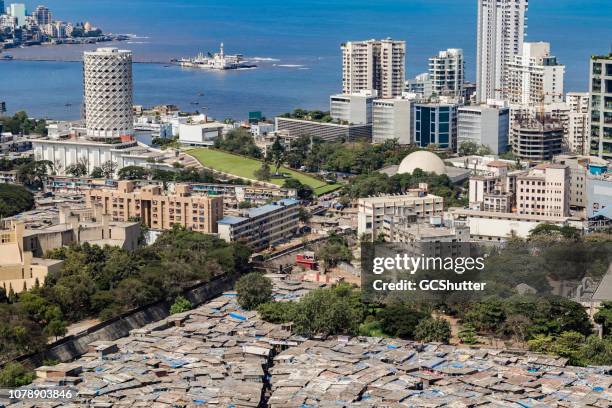 rooftop image of slums, buildings and neighboring community - mumbai, maharashtra - mumbai slums stock pictures, royalty-free photos & images